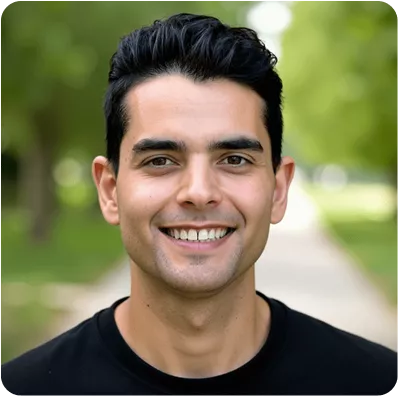 Smiling young man portrait outdoors with green background