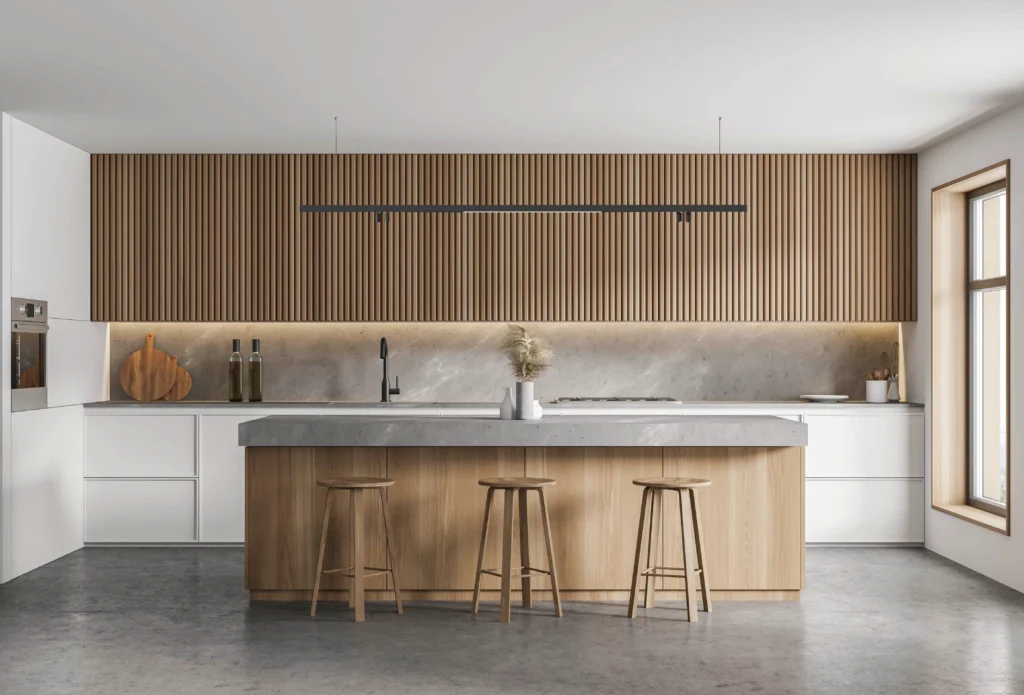 Modern minimalist kitchen with wooden slat wall, island counter, and linear pendant light